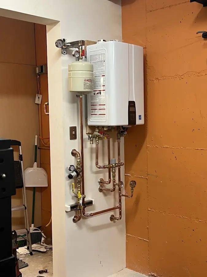 Plumbing technician inspecting water heater connections in Lake Elsinore